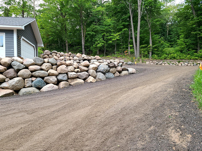 Exterior of shed and garage after landscaping with rocks